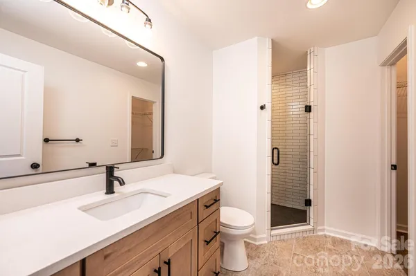 a bathroom with a sink toilet a shower and a mirror