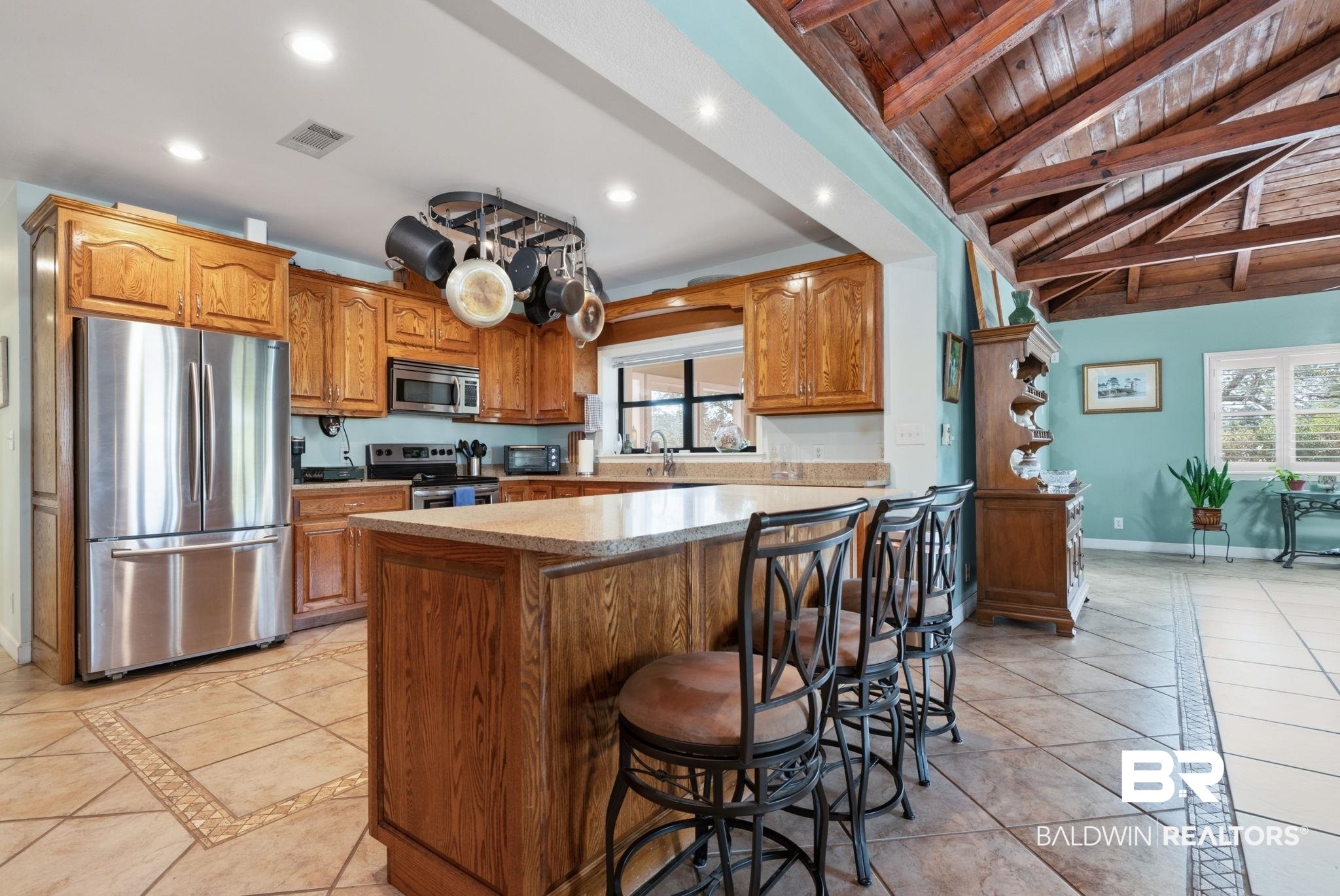 15025 Bellingrath Road Coden, AL 36523 - Photo 43 of 79 Kitchen with inlaid floor details, stainless steel appliances, a breakfast bar area, wood finish cabinets, and recessed lighting