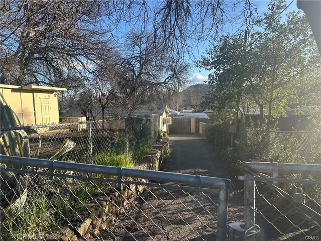 a view of a balcony with wooden floor and fence