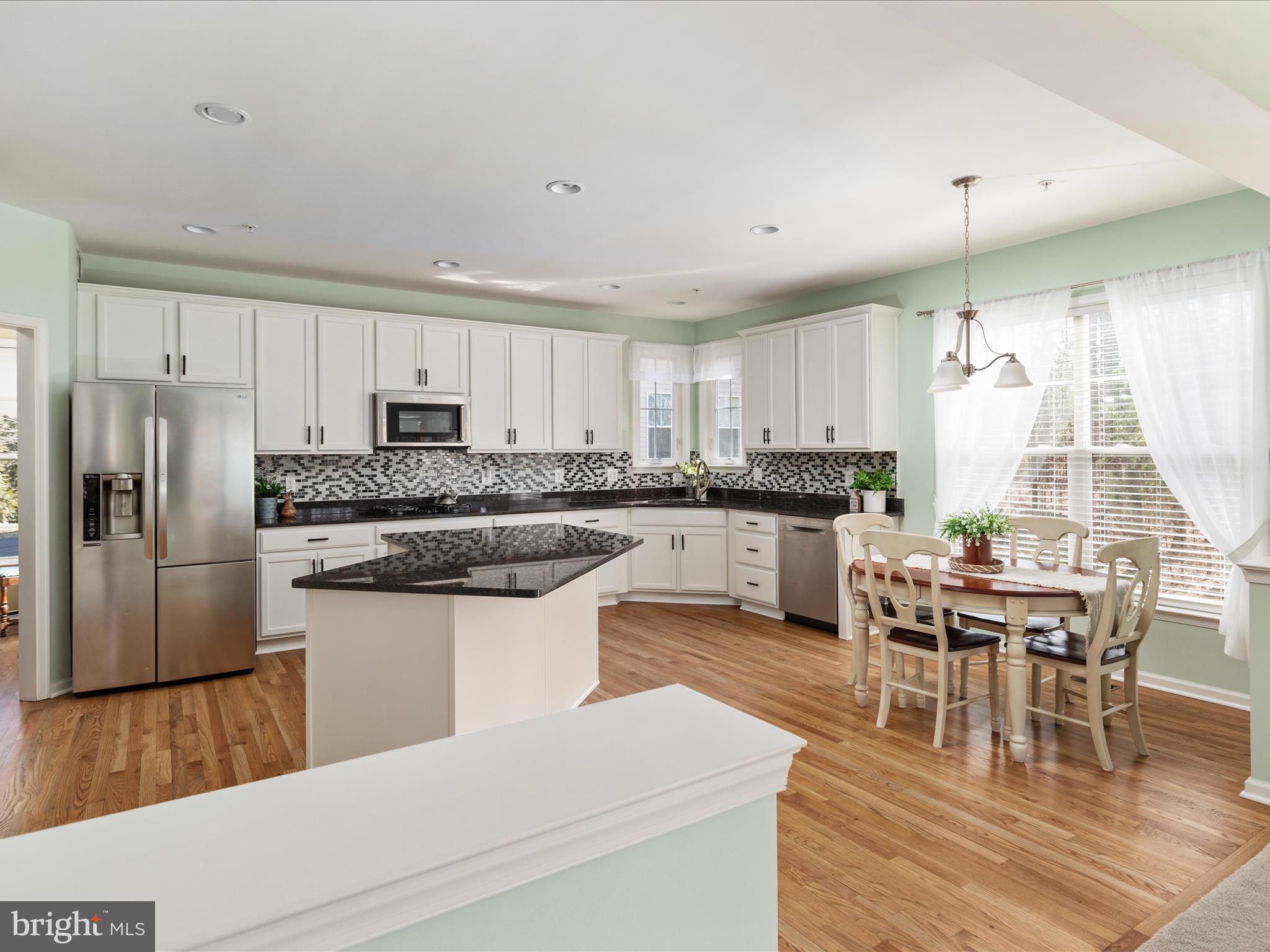 14353 Northbrook Lane Gainesville, VA 20155 - Photo 11 of 63 a kitchen with stainless steel appliances granite countertop a white cabinets and a refrigerator