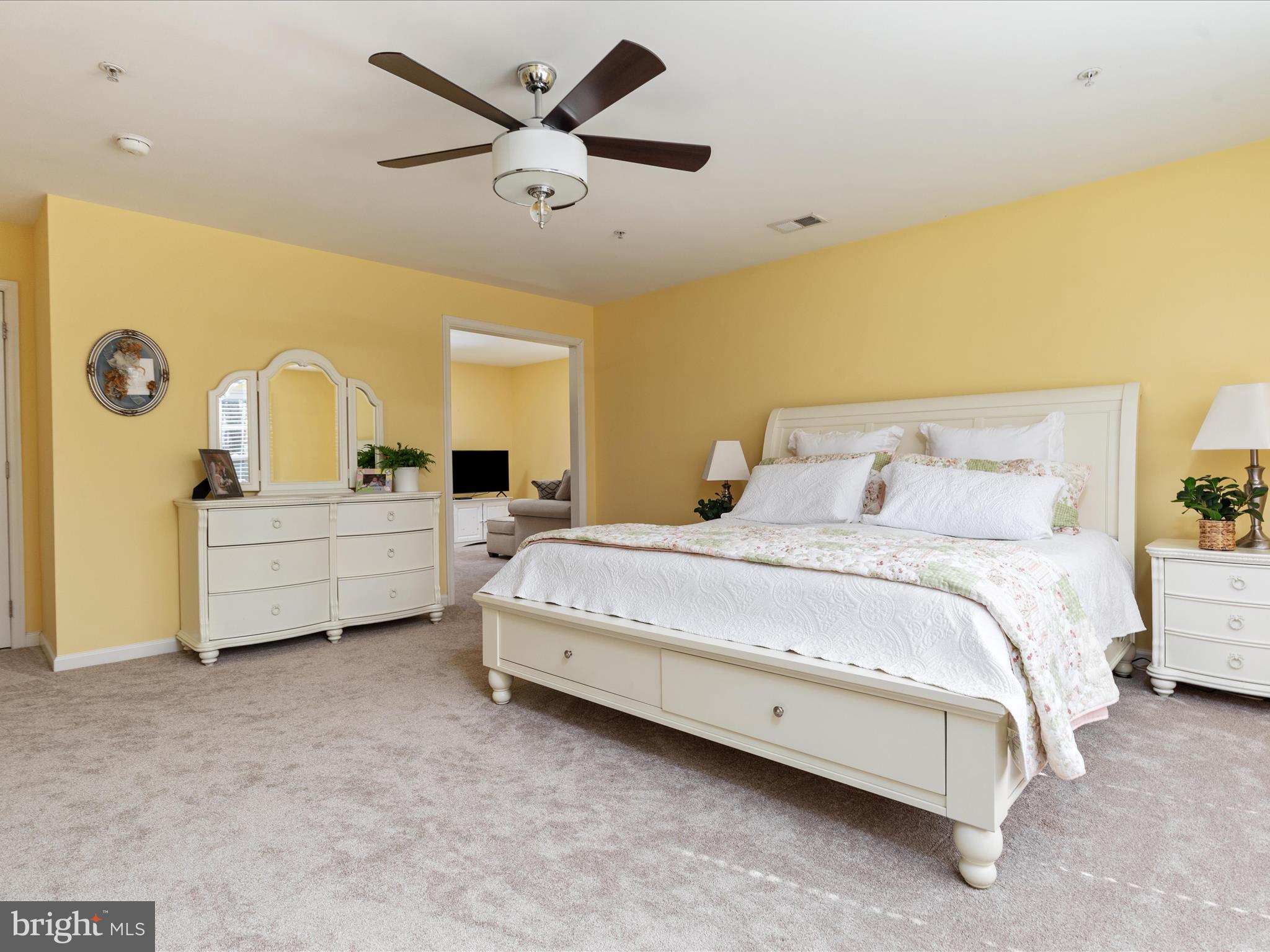 14353 Northbrook Lane Gainesville, VA 20155 - Photo 22 of 63 a spacious bedroom with a bed a dresser next to a window