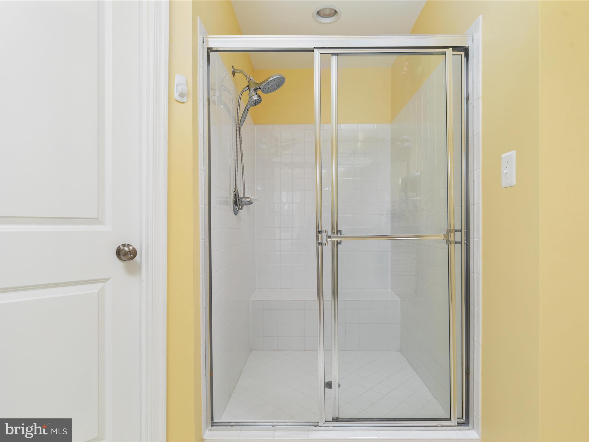 14353 Northbrook Lane Gainesville, VA 20155 - Photo 27 of 63 a bathroom with a glass shower door