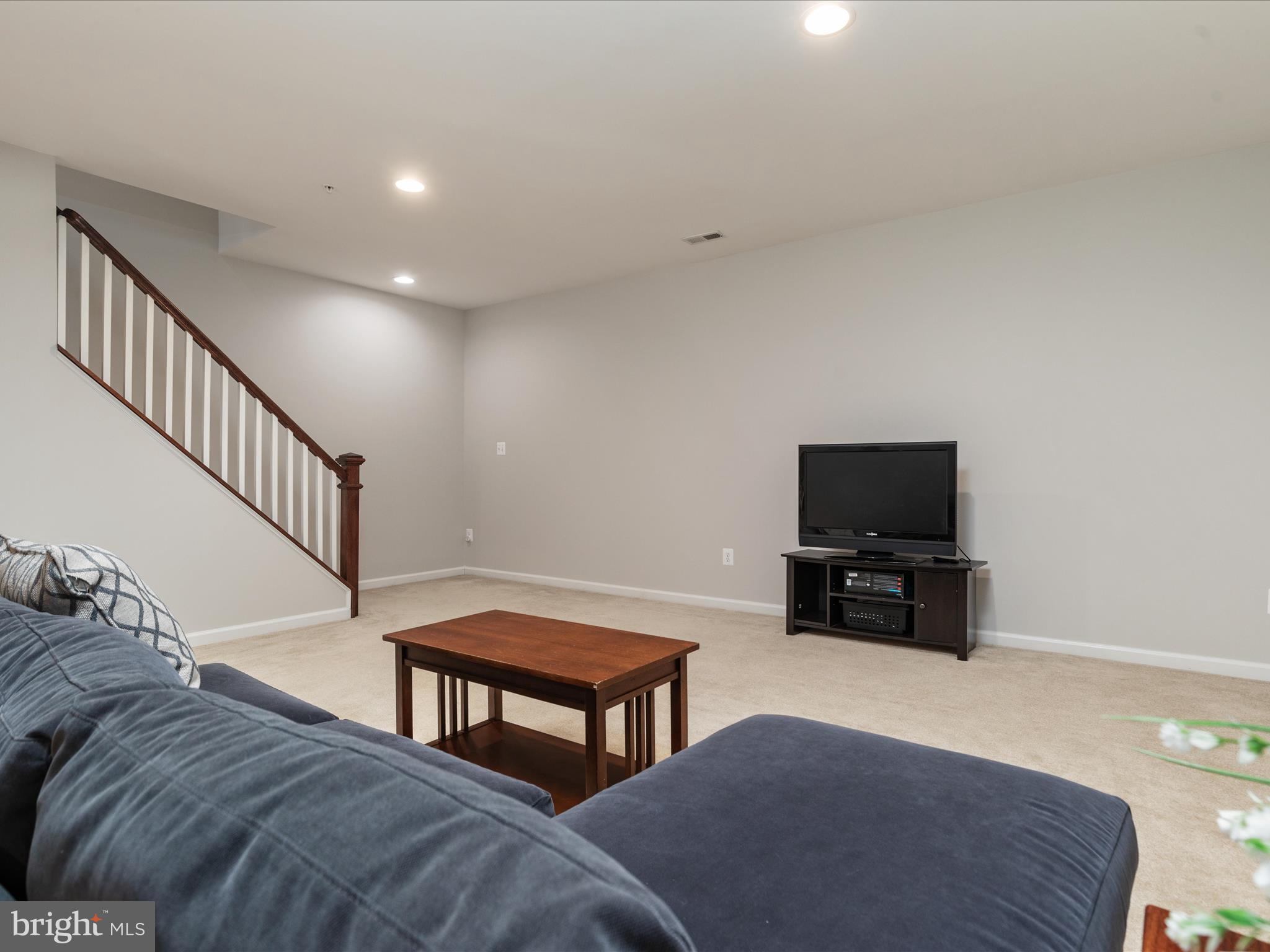14353 Northbrook Lane Gainesville, VA 20155 - Photo 28 of 63 a living room with furniture and a flat screen tv