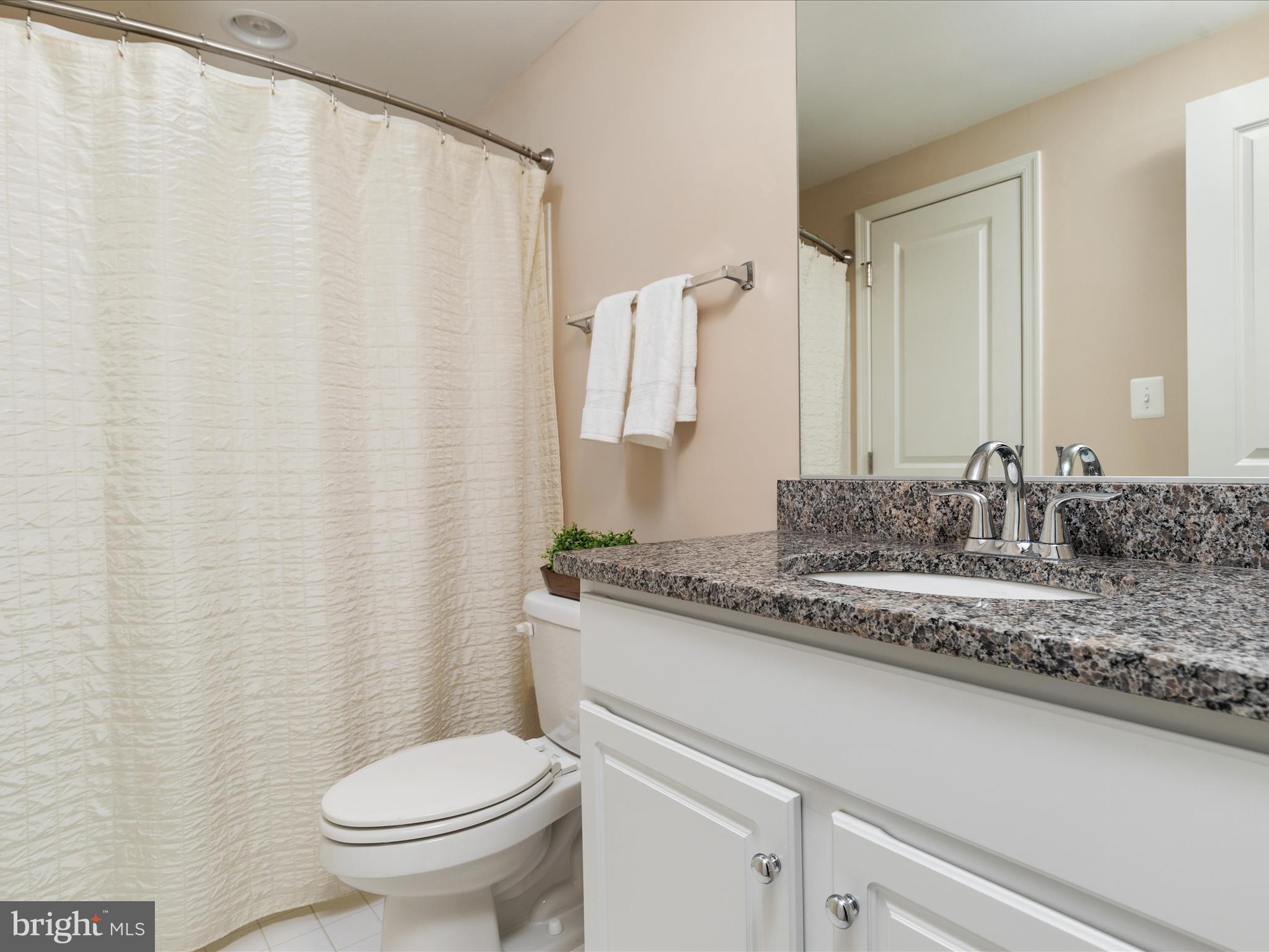 14353 Northbrook Lane Gainesville, VA 20155 - Photo 33 of 63 a bathroom with a granite countertop sink and a toilet