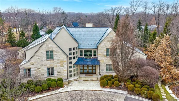a aerial view of a house next to a yard