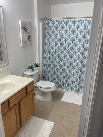 a large bed sitting in a bedroom next to a window