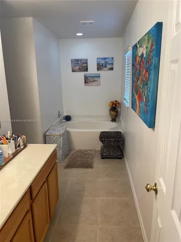 a bathroom with a sink a large mirror and a shower