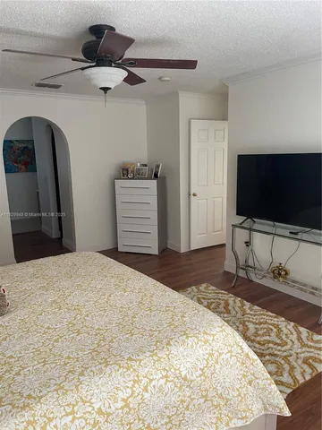 a view of a hallway with wooden floor and entryway
