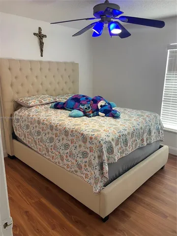 a room with wooden floor and white walls