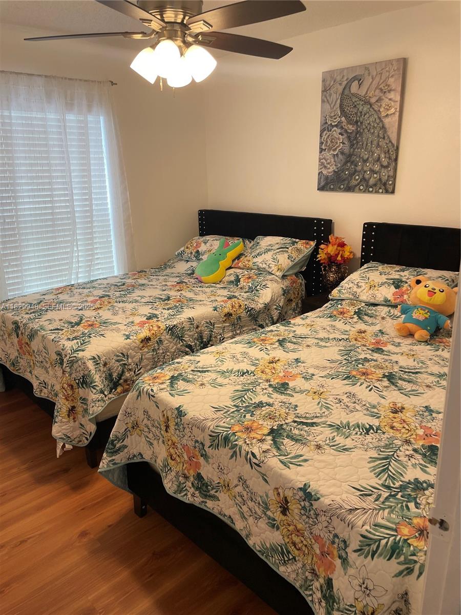 2645 12th Square Southwest Vero Beach, FL 32968 - Photo 22 of 22 a bedroom with a bed and a chandelier