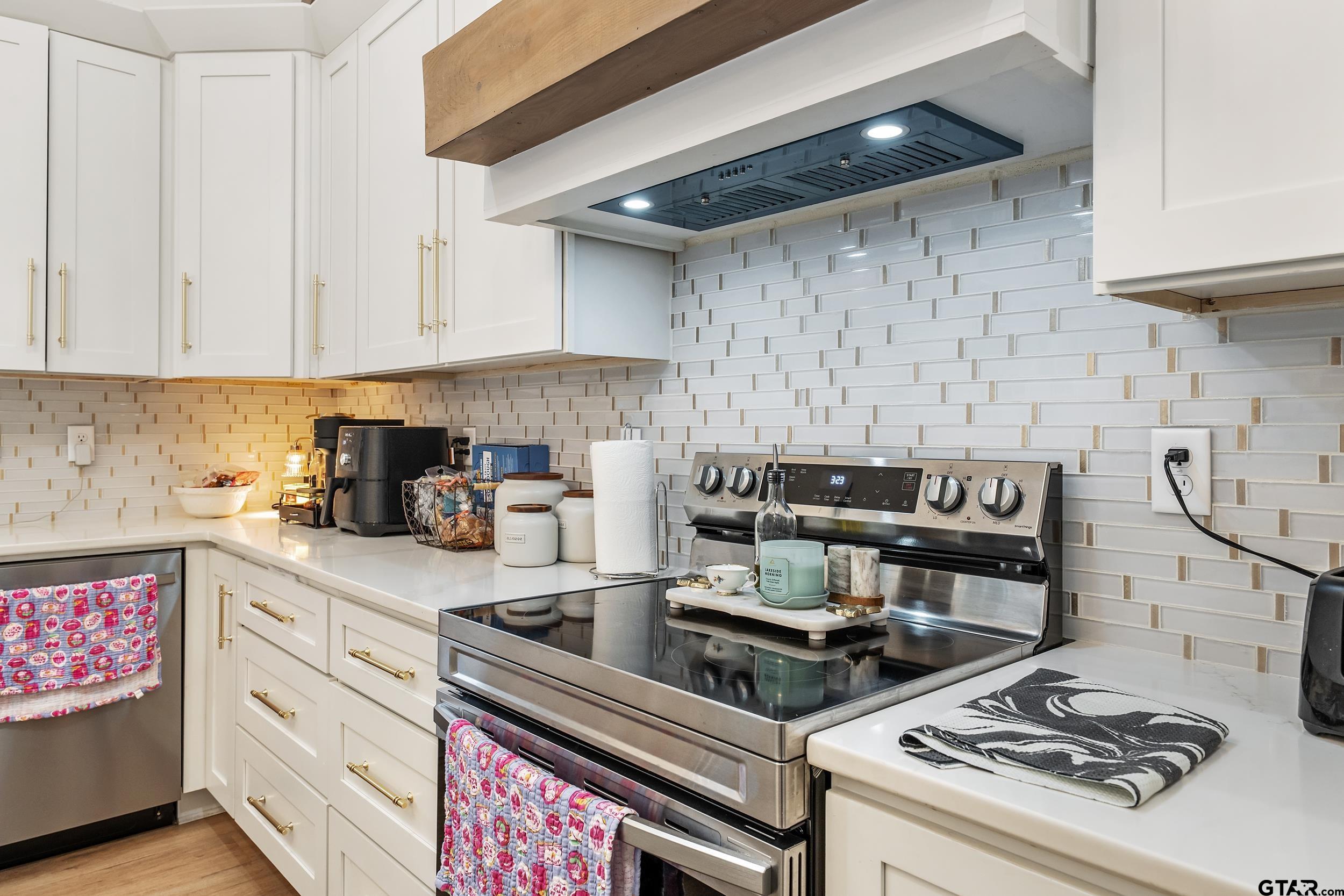 16837 Wilson Road Tyler, TX 75707 - Photo 18 of 44 a kitchen with a stove and a white cabinets