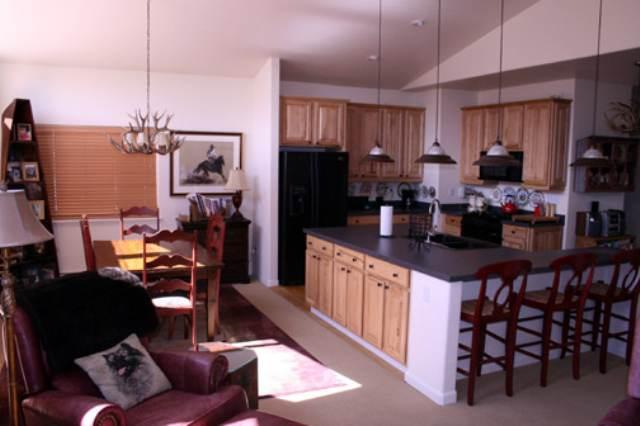 46 Pine Ridge Road, Unit 5 Basalt, CO 81621 - Photo 2 of 9 a kitchen with stainless steel appliances kitchen island granite countertop a refrigerator and microwave