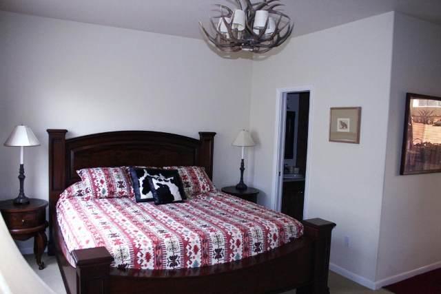 46 Pine Ridge Road, Unit 5 Basalt, CO 81621 - Photo 3 of 9 a bedroom with a bed and a chandelier