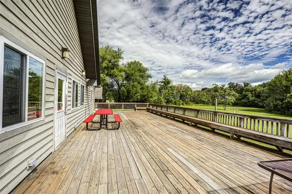 a view of balcony with wooden floor and fence