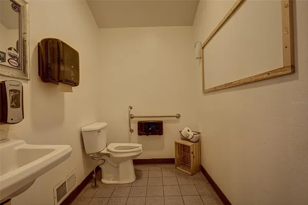 a kitchen with a stove top oven and cabinets