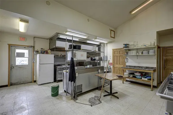 a kitchen with stainless steel appliances a stove a sink and a refrigerator