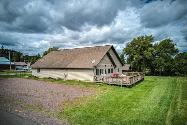 a front view of a house with a garden and yard