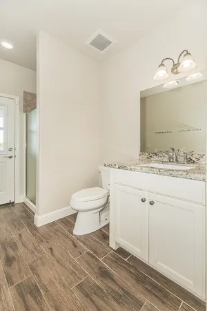 a spacious bathroom with a granite countertop sink mirror and a