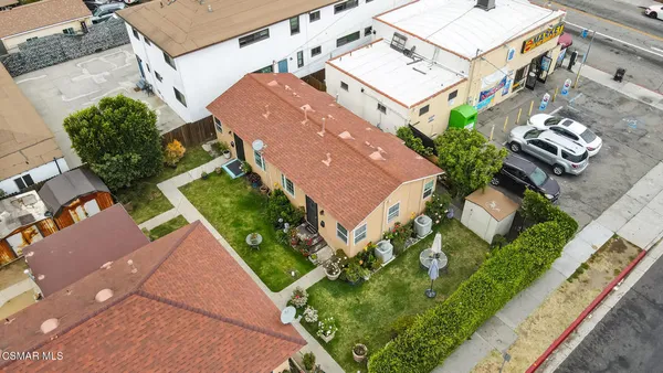 an aerial view of residential houses with outdoor space