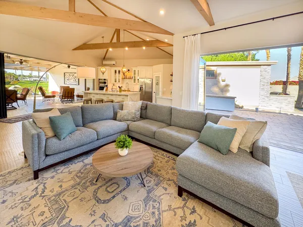 a living room with furniture and a chandelier