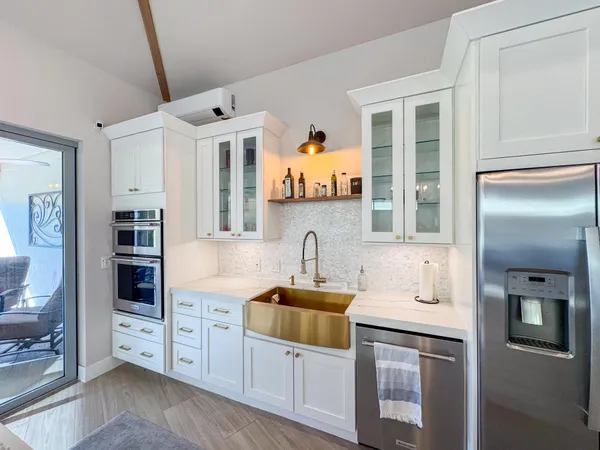 a kitchen with stainless steel appliances granite countertop a refrigerator and a stove top oven