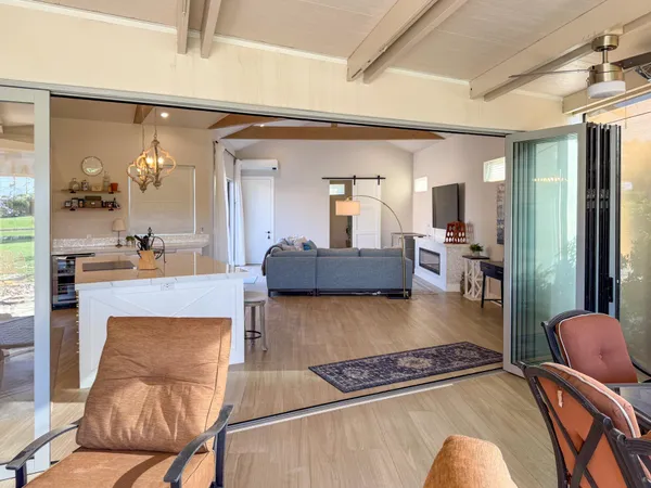 a living room with furniture and wooden floor