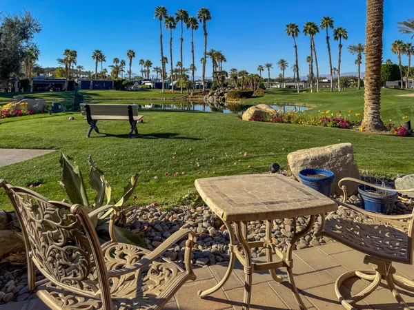 a view of a table and chairs in patio and a yard