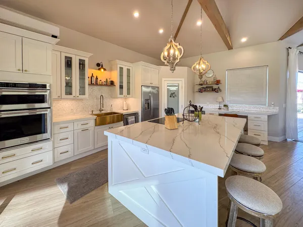 a large kitchen with cabinets a sink and a stove