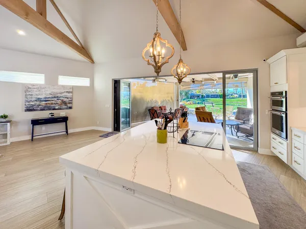 a living room with furniture and a floor to ceiling window