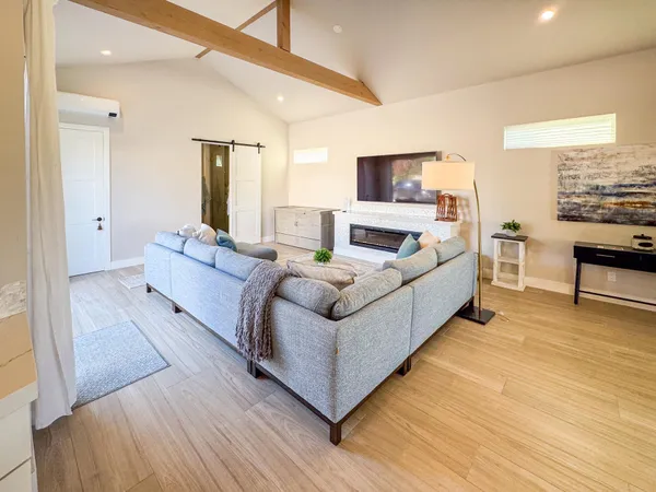 a living room with furniture and a wooden floor