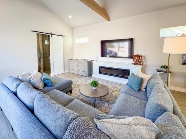 a living room with furniture and a lamp