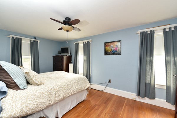 28 Partridge Road Weymouth, MA 02190 - Photo 14 of 22 a bedroom with a large bed and a chandelier