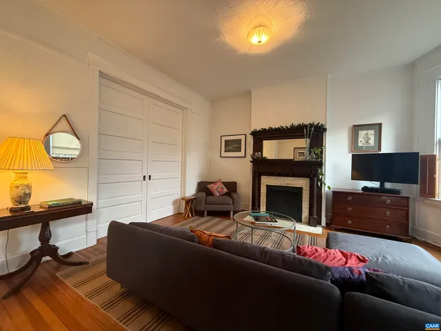 a living room with furniture a flat screen tv and a fireplace