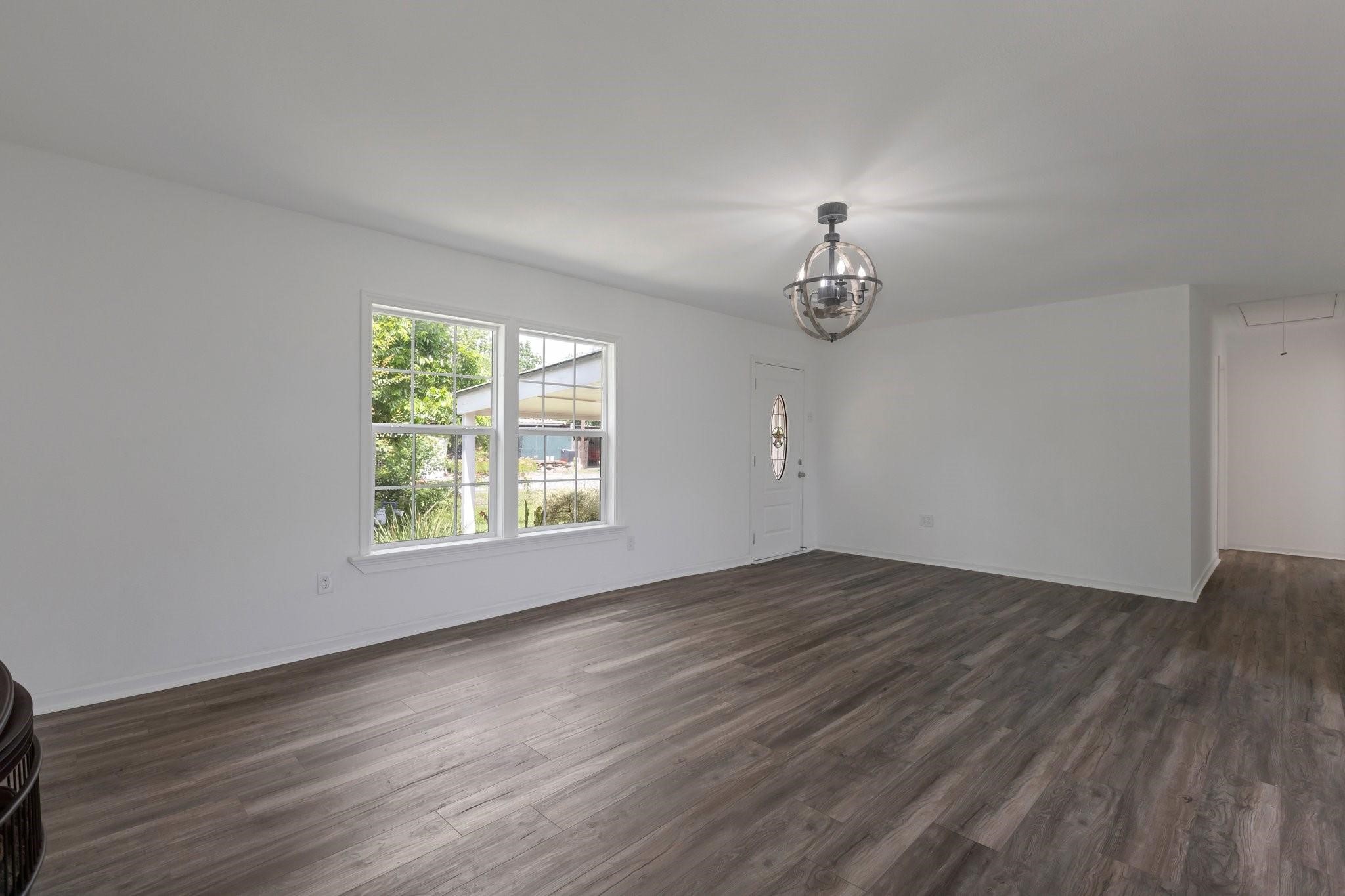 639 Manor Street Houston, TX 77015 - Photo 16 of 31 an empty room with wooden floor cabinet and windows