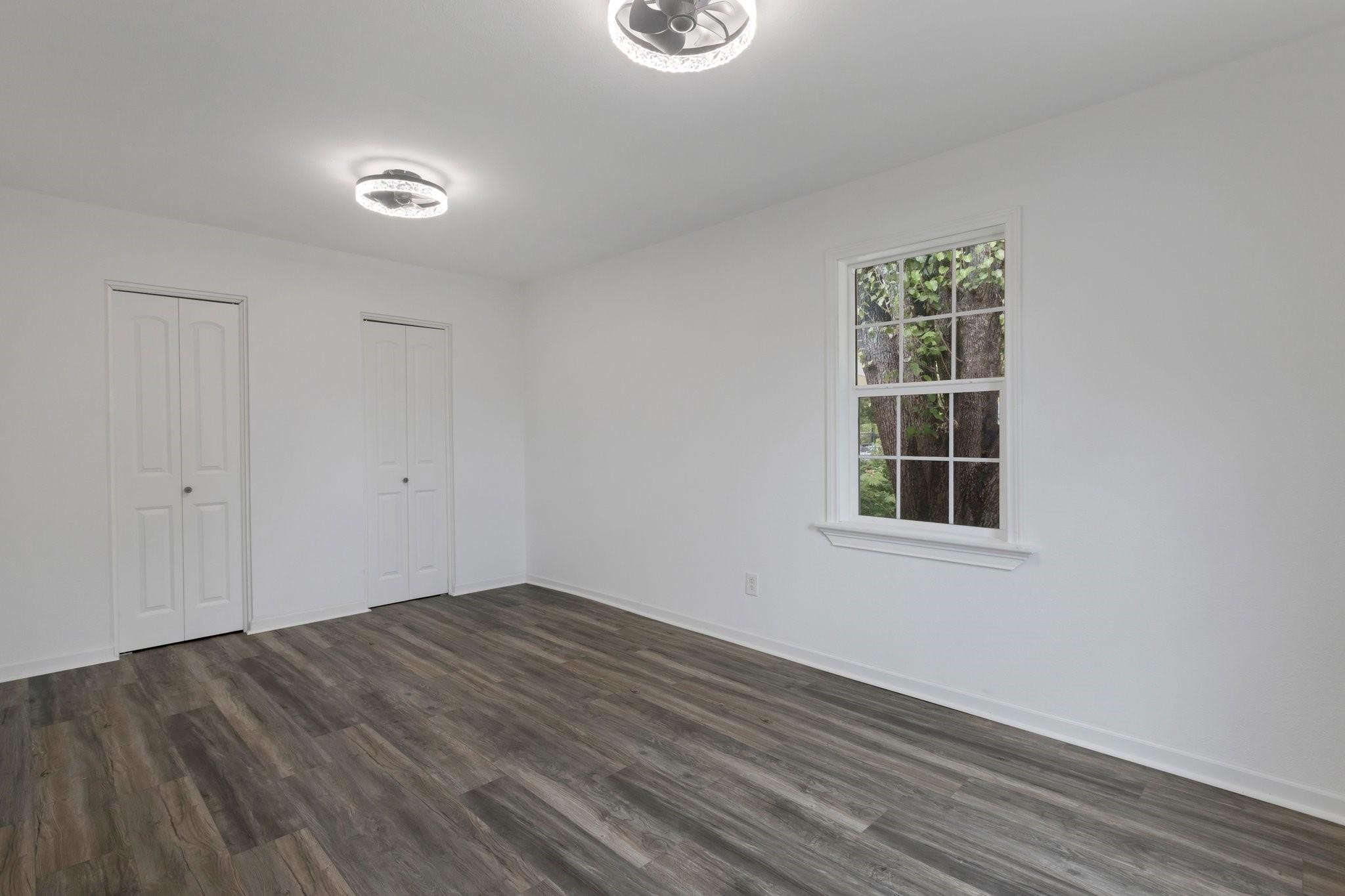 639 Manor Street Houston, TX 77015 - Photo 23 of 31 an empty room with wooden floor and windows