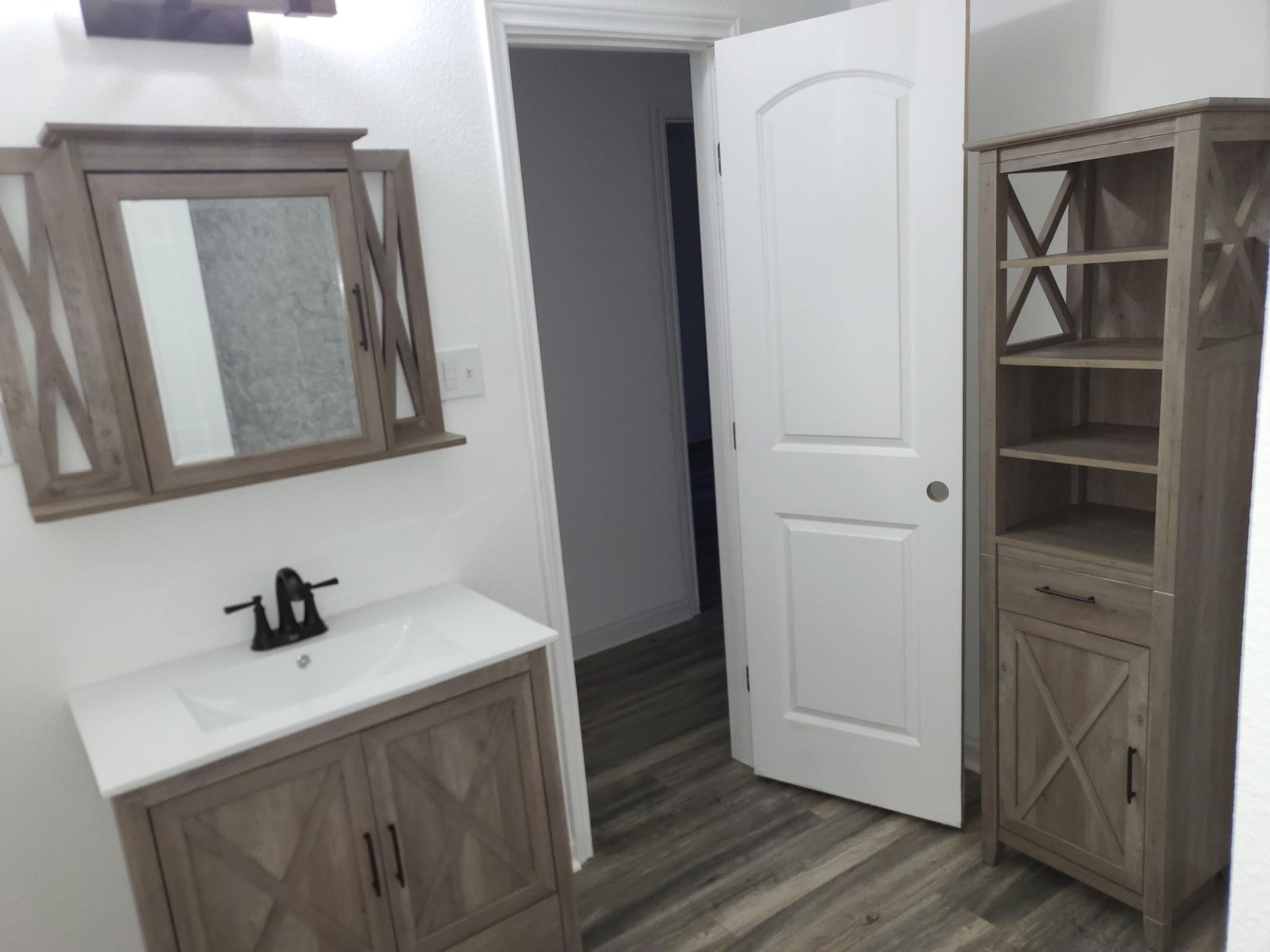 639 Manor Street Houston, TX 77015 - Photo 24 of 31 a bathroom with a sink and a mirror