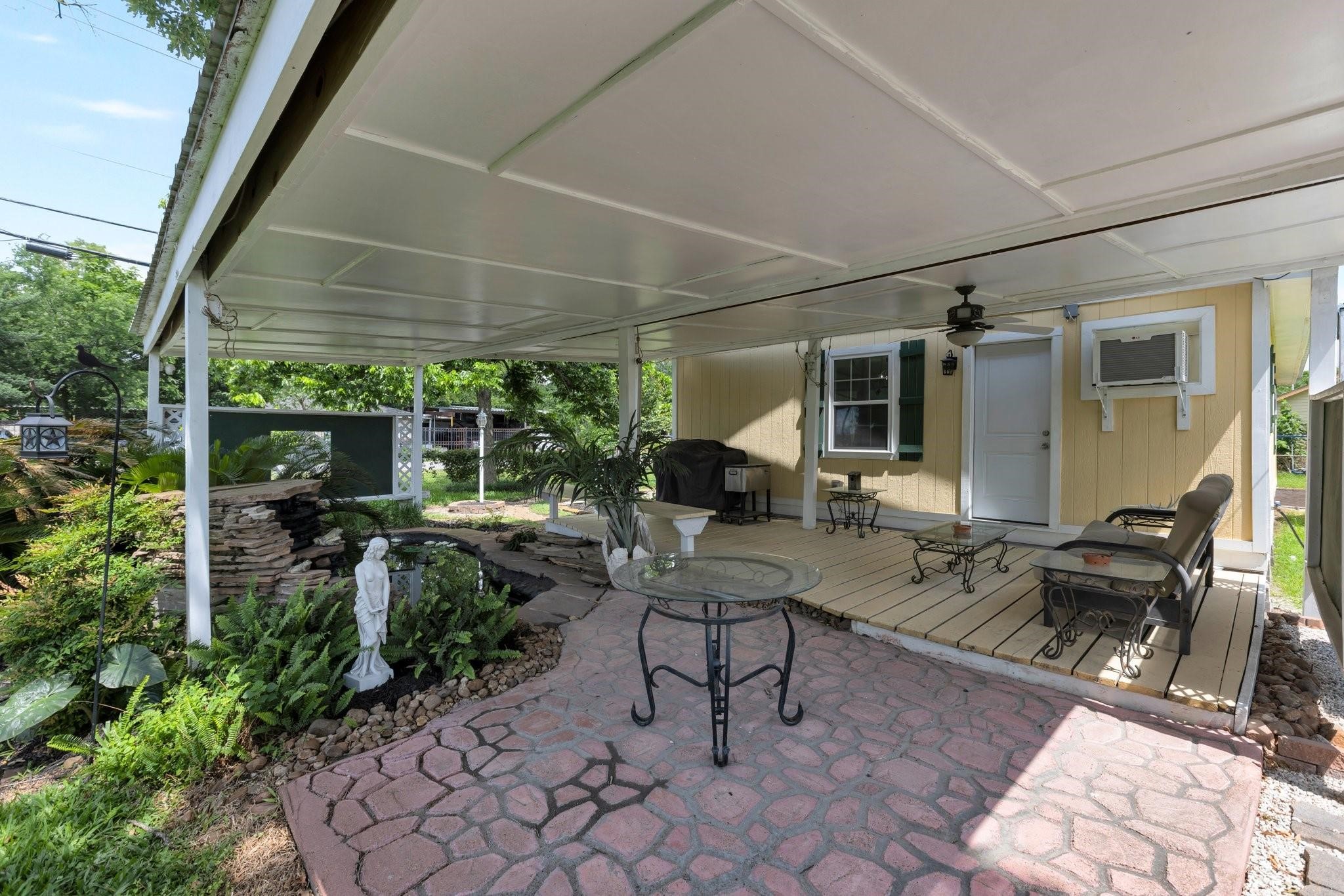 639 Manor Street Houston, TX 77015 - Photo 10 of 31 a view of a patio with table and chairs potted plants and floor to ceiling window