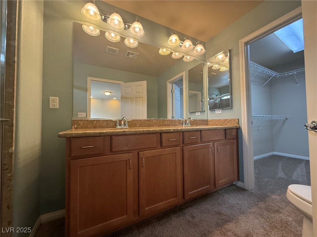 6830 Philharmonic Avenue Las Vegas, NV 89139 - Photo 13 of 28 Full bathroom featuring double sinks, shower, & va