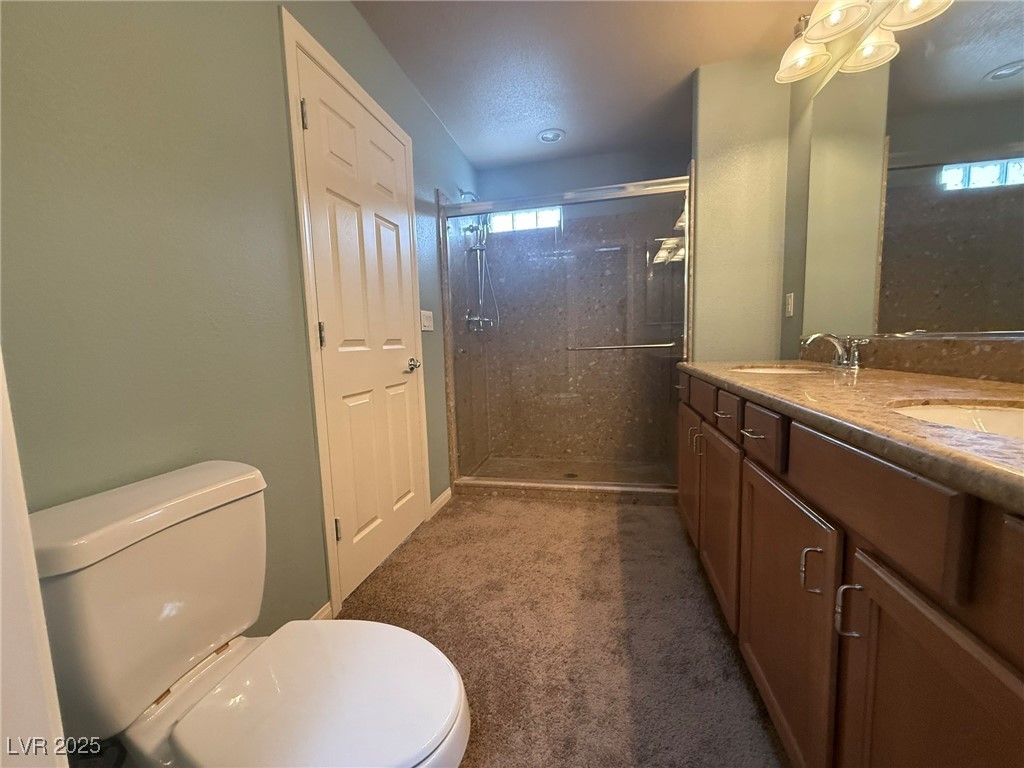 6830 Philharmonic Avenue Las Vegas, NV 89139 - Photo 16 of 28 Full bathroom featuring double sinks, shower, & va