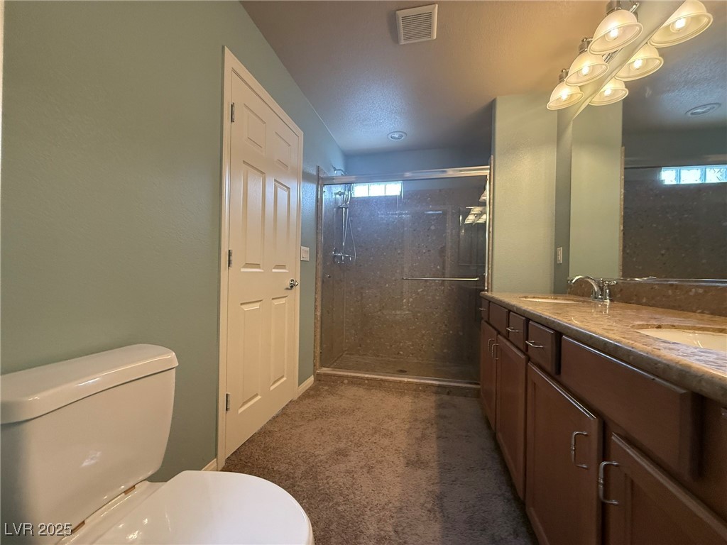 6830 Philharmonic Avenue Las Vegas, NV 89139 - Photo 17 of 28 Full bathroom featuring double sinks, shower, & va