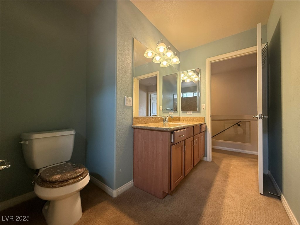 6830 Philharmonic Avenue Las Vegas, NV 89139 - Photo 21 of 28 Bathroom with baseboards, vanity, and toilet