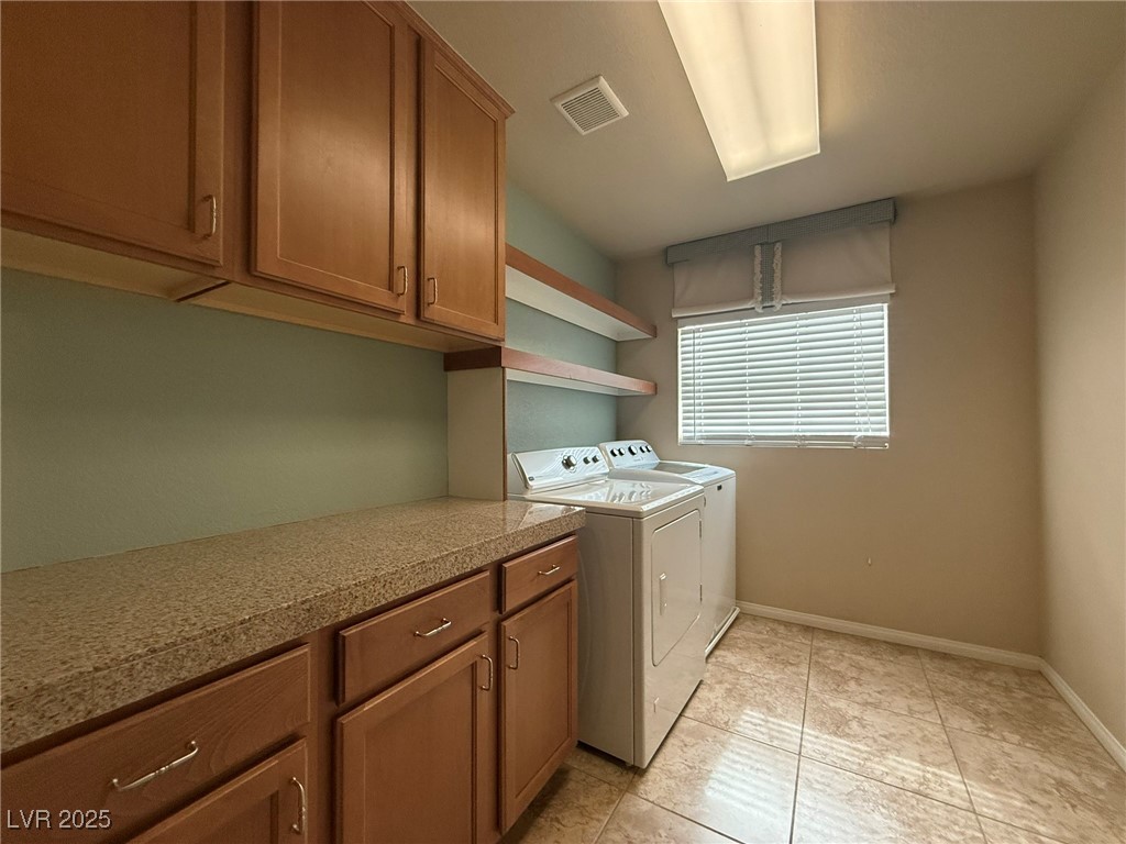6830 Philharmonic Avenue Las Vegas, NV 89139 - Photo 24 of 28 Laundry room featuring cabinet space, light tile p
