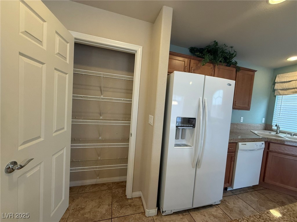 6830 Philharmonic Avenue Las Vegas, NV 89139 - Photo 8 of 28 Kitchen featuring light tile patterned floors, whi