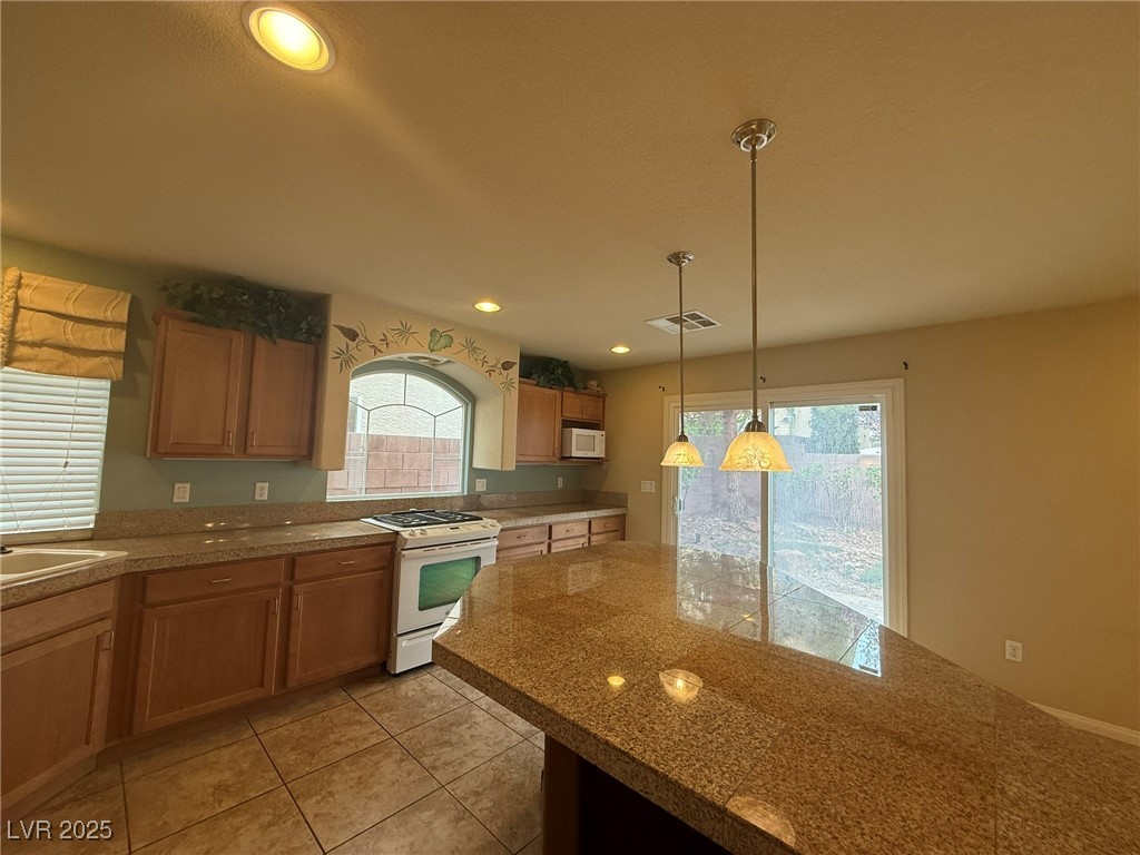 6830 Philharmonic Avenue Las Vegas, NV 89139 - Photo 9 of 28 Kitchen featuring light tile patterned floors, whi