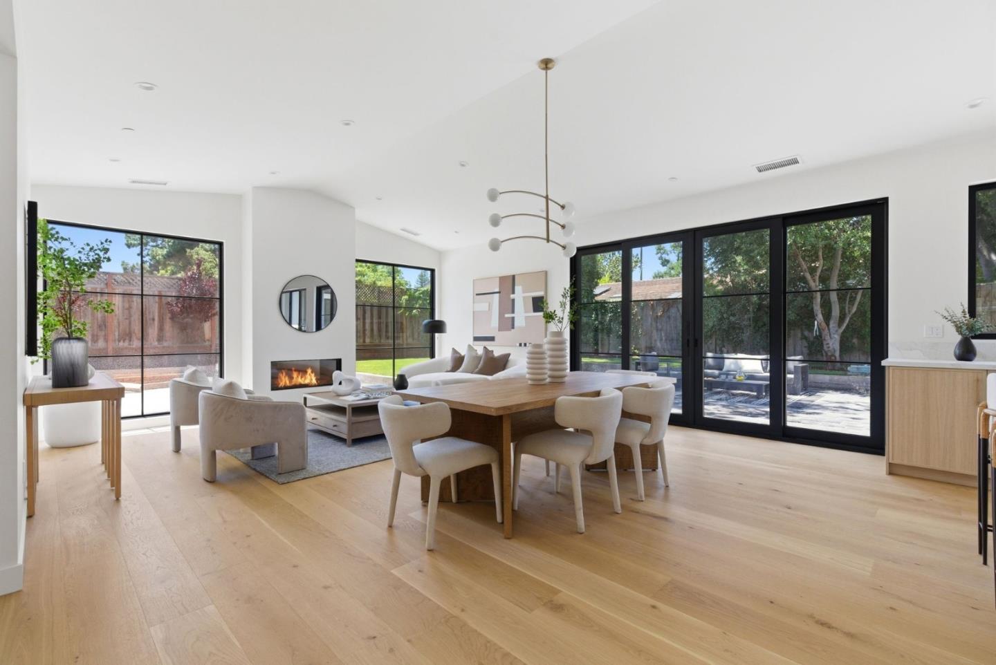 680 North San Antonio Road Los Altos, CA 94022 - Photo 5 of 19 a living room with furniture a large window and a chandelier