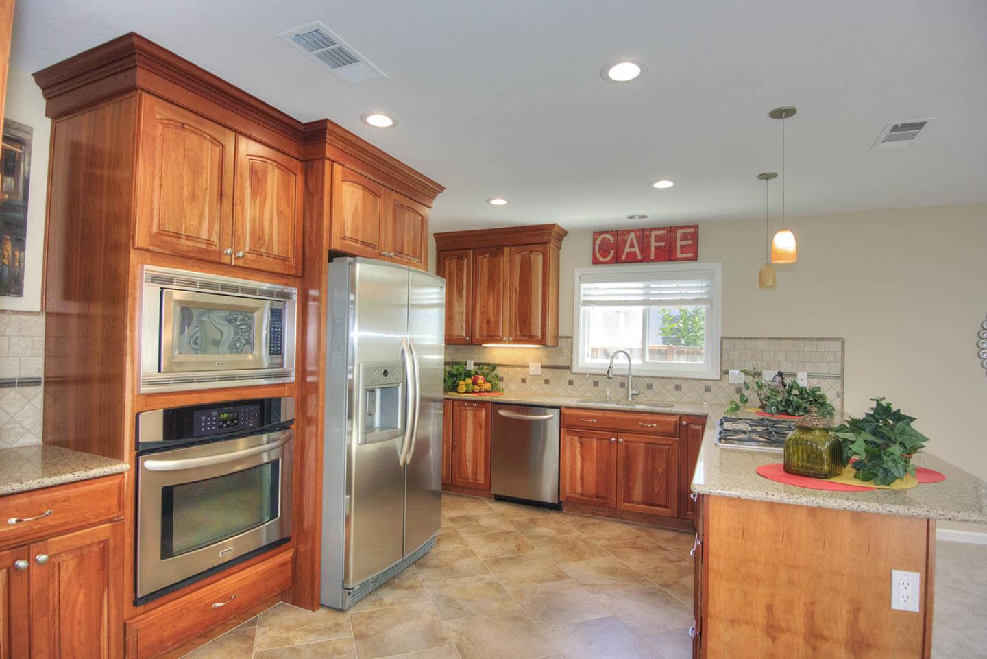 3792 Savannah Road Fremont, CA 94538 - Photo 12 of 37 a kitchen with stainless steel appliances granite countertop a refrigerator and a stove top oven