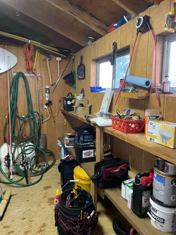a storage room with lots of clutter and chairs