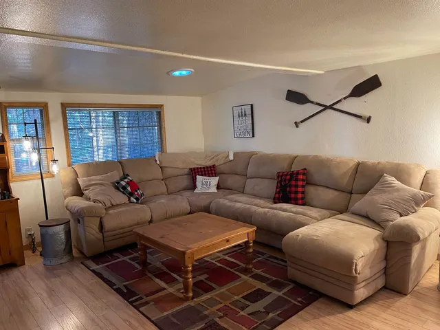 a living room with furniture a ceiling fan and a window