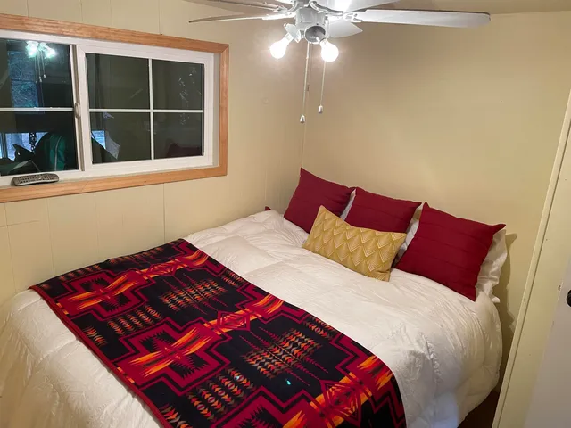 a bedroom with a bed and window