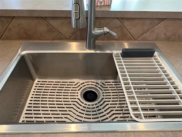 a kitchen with kitchen island a sink stainless steel appliances and cabinets